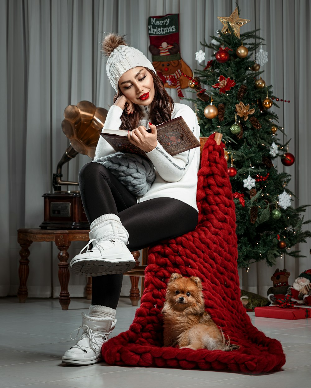 woman in black jacket sitting on red chair reading book