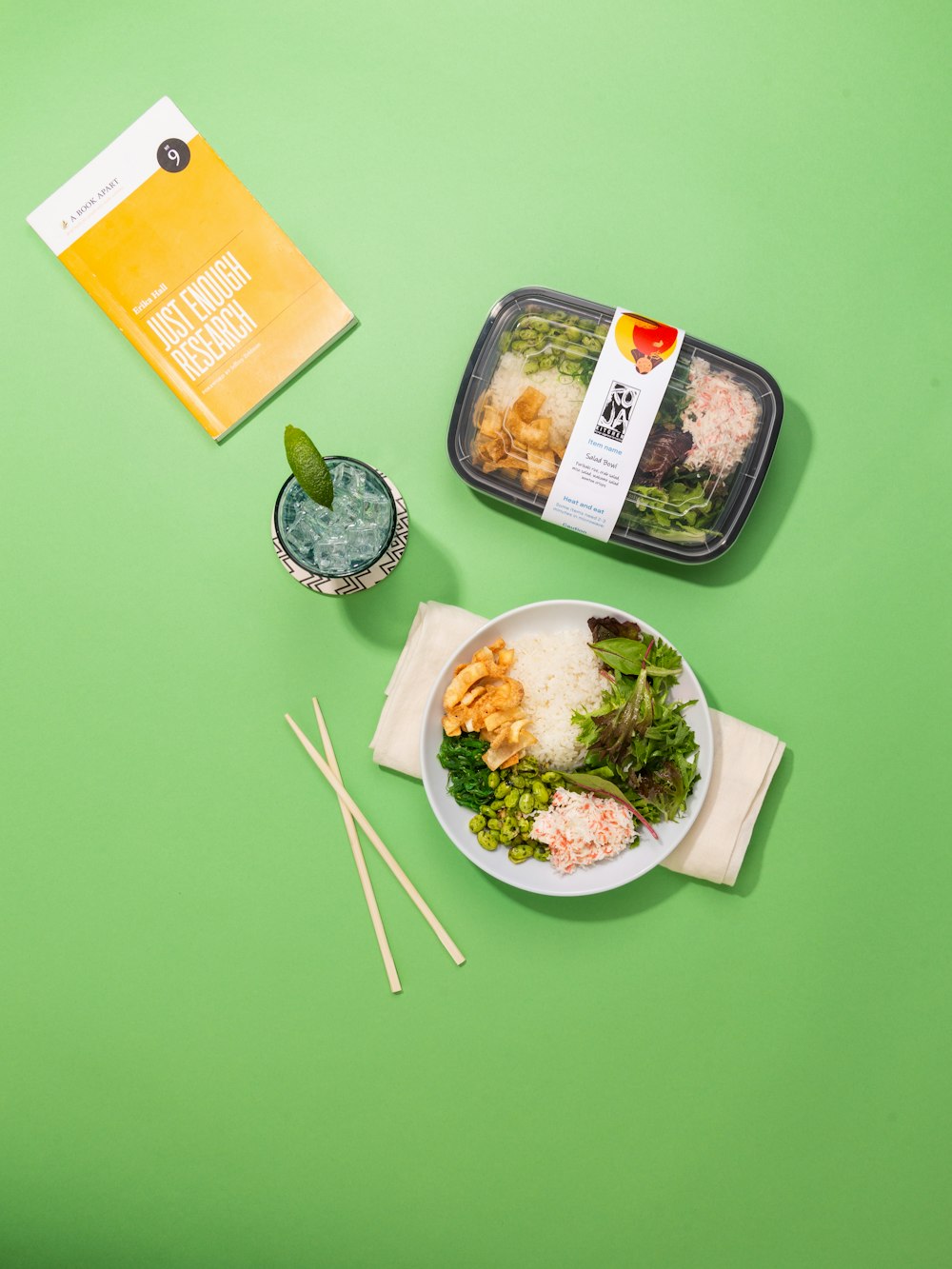 white and green plastic food container on green table