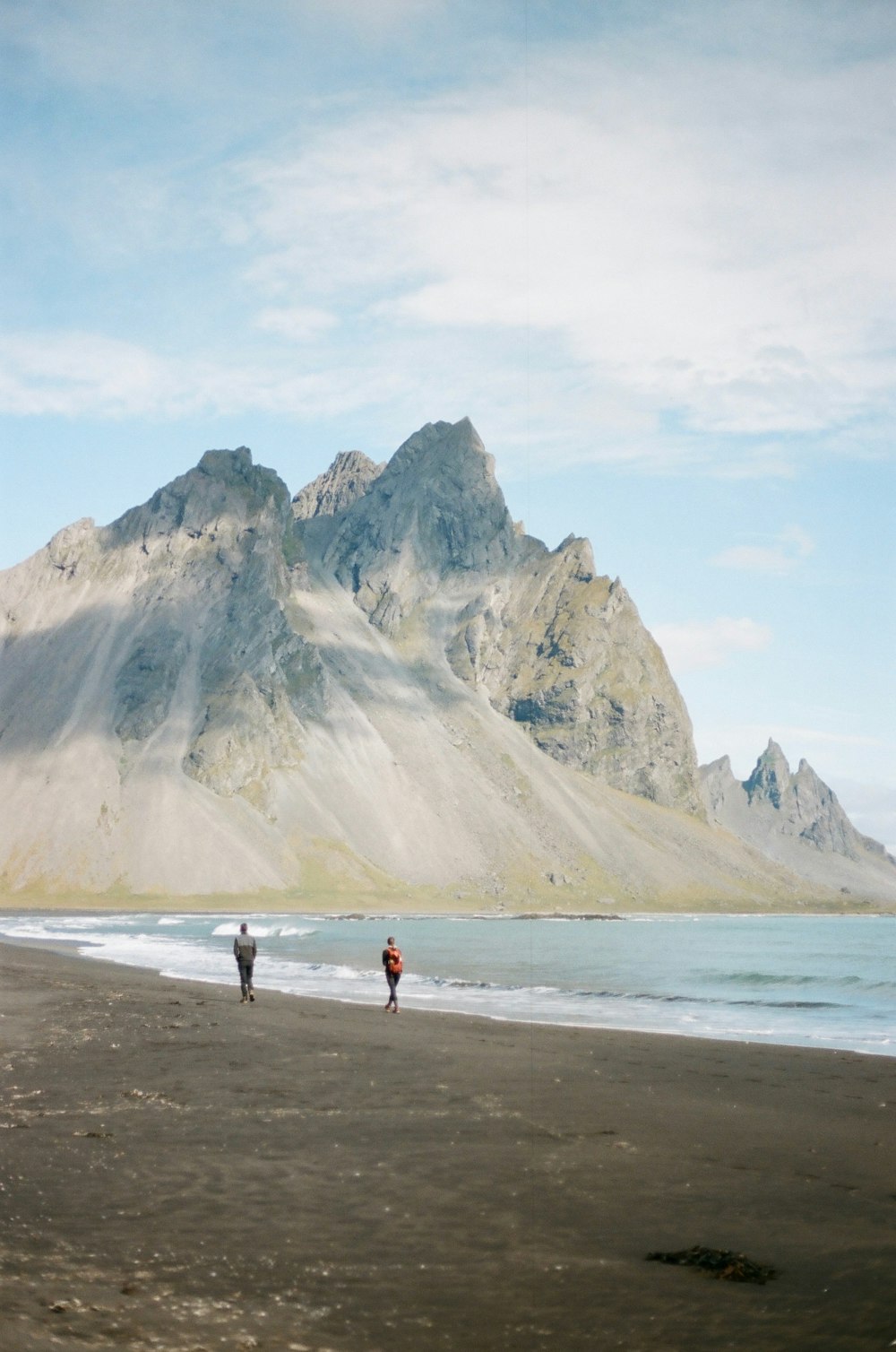 2 person walking on beach during daytime