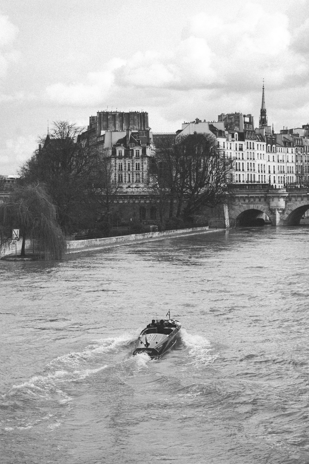 grayscale photo of boat on river