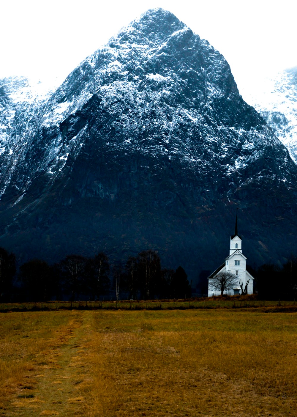 white and gray concrete building near mountain