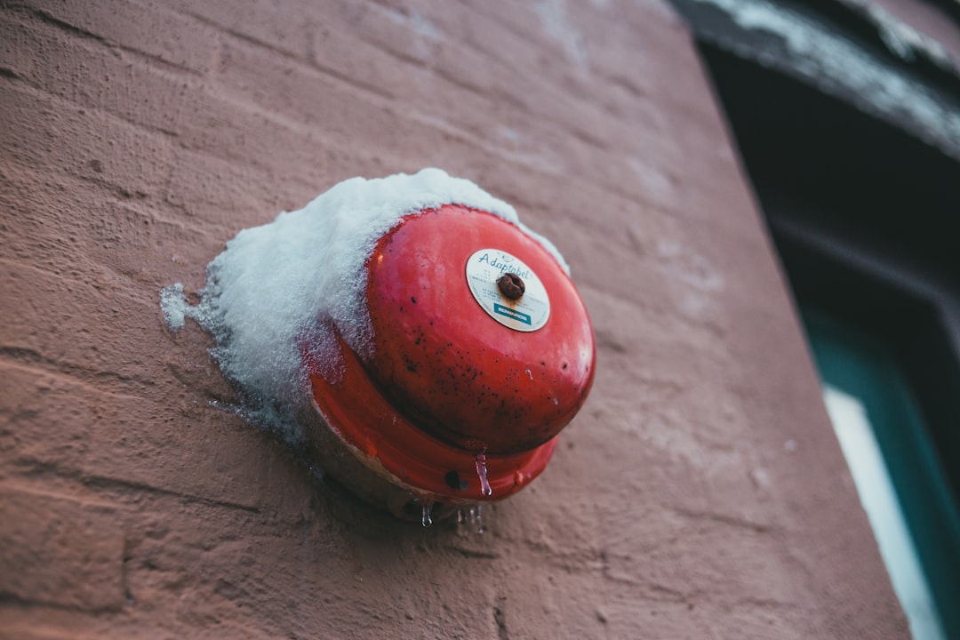 red and white round ornament on brown wooden table