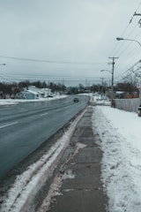 Snow-covered road with connected devices monitoring conditions.