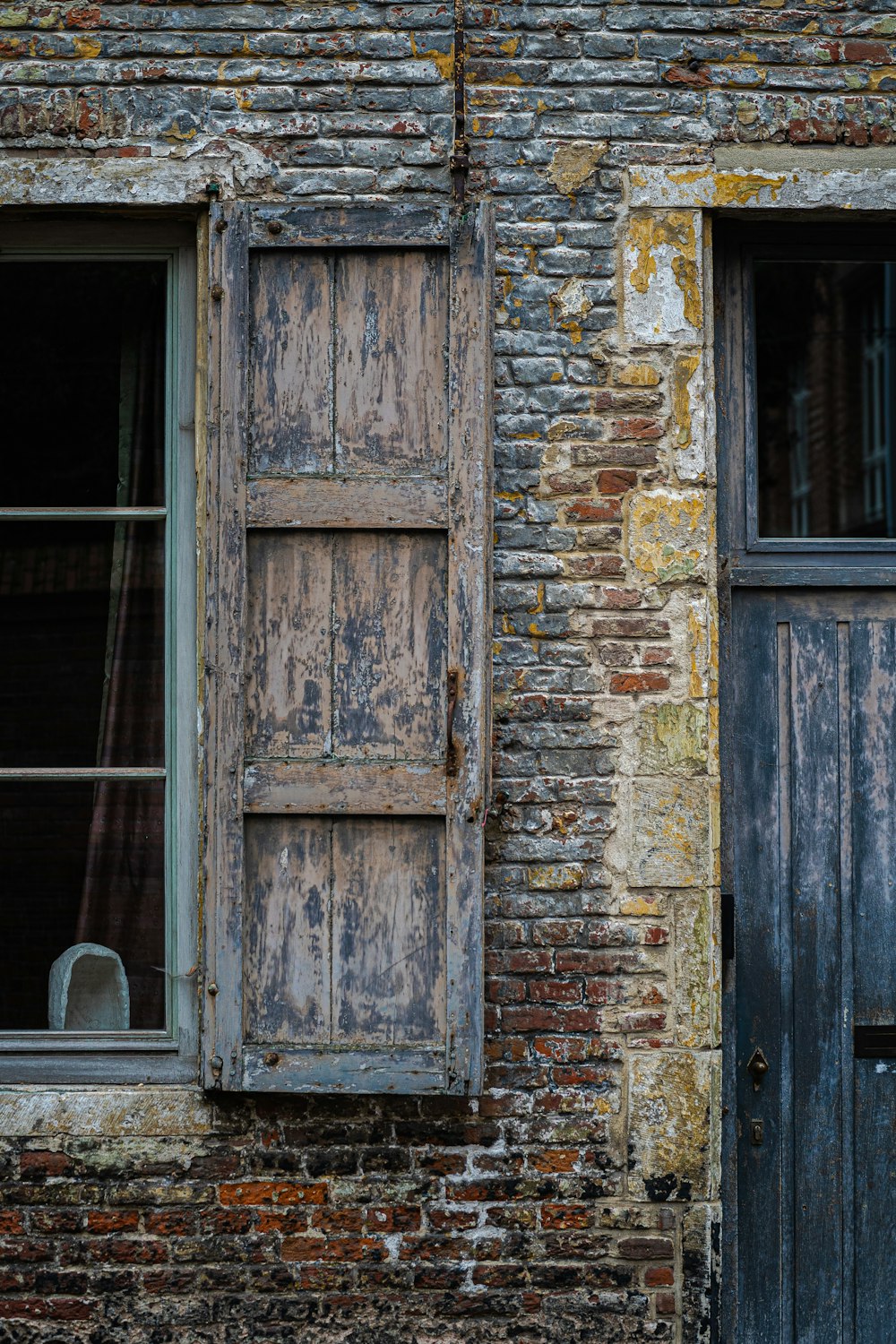 brown wooden door on brick wall