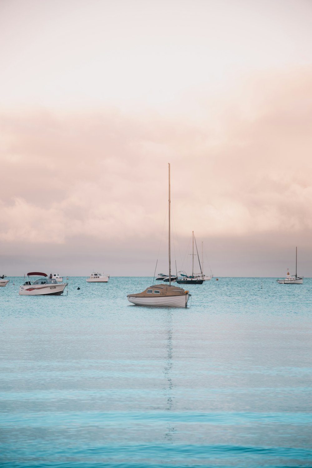 white sail boat on sea during daytime