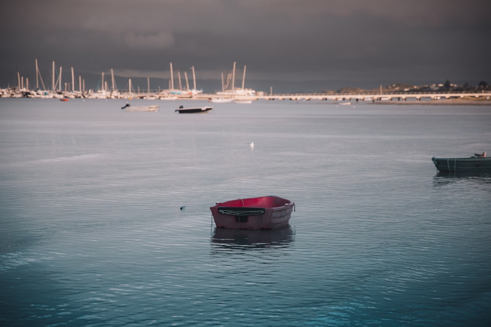 red and blue boat on sea during daytime