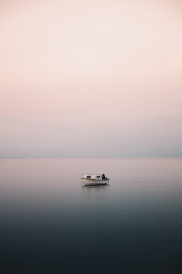 white boat on body of water during daytime