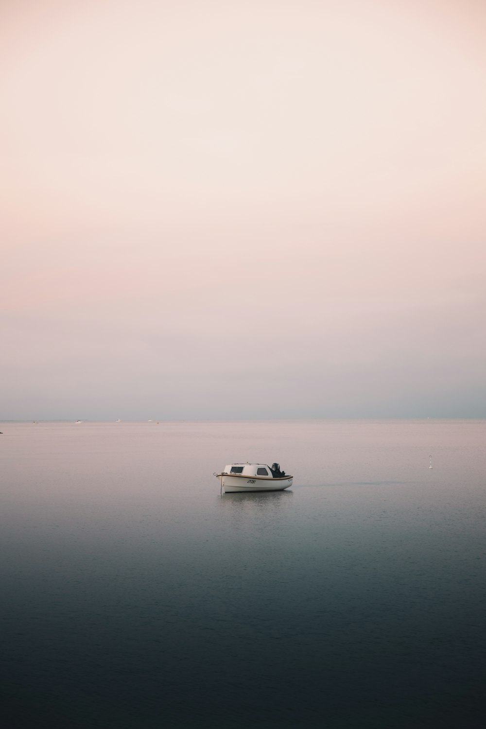 white boat on body of water during daytime