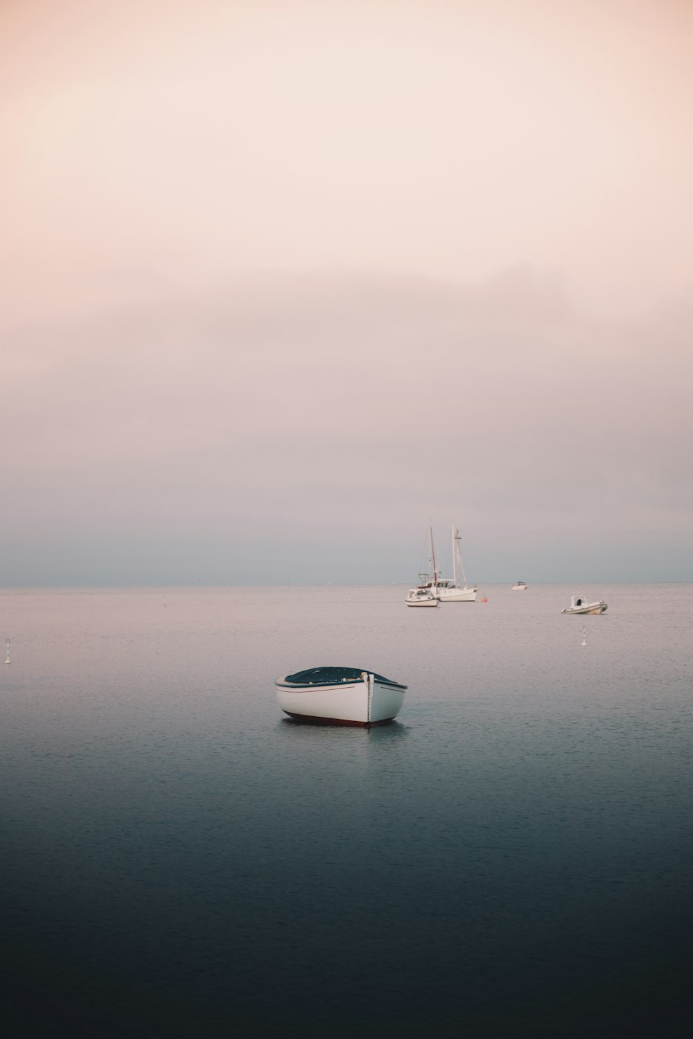 white boat on sea under gray sky