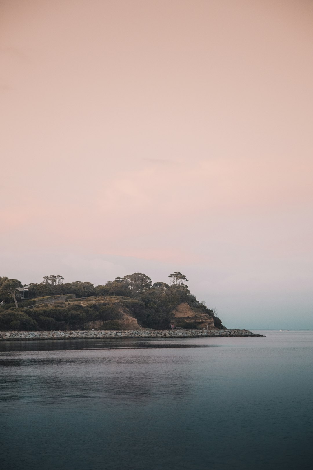 brown and green island on body of water during daytime