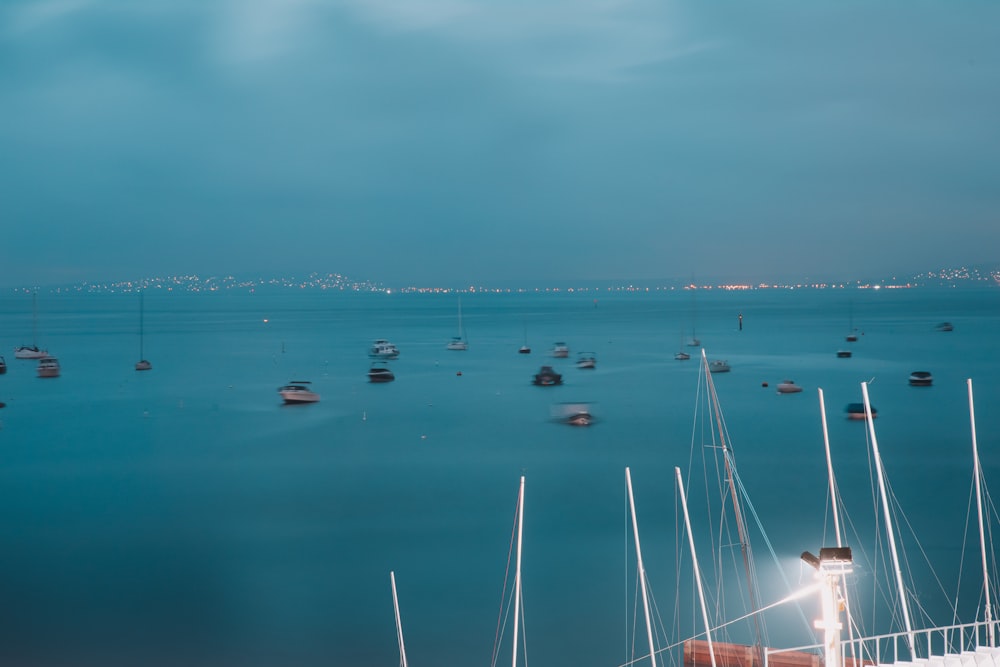 boats on sea under gray sky