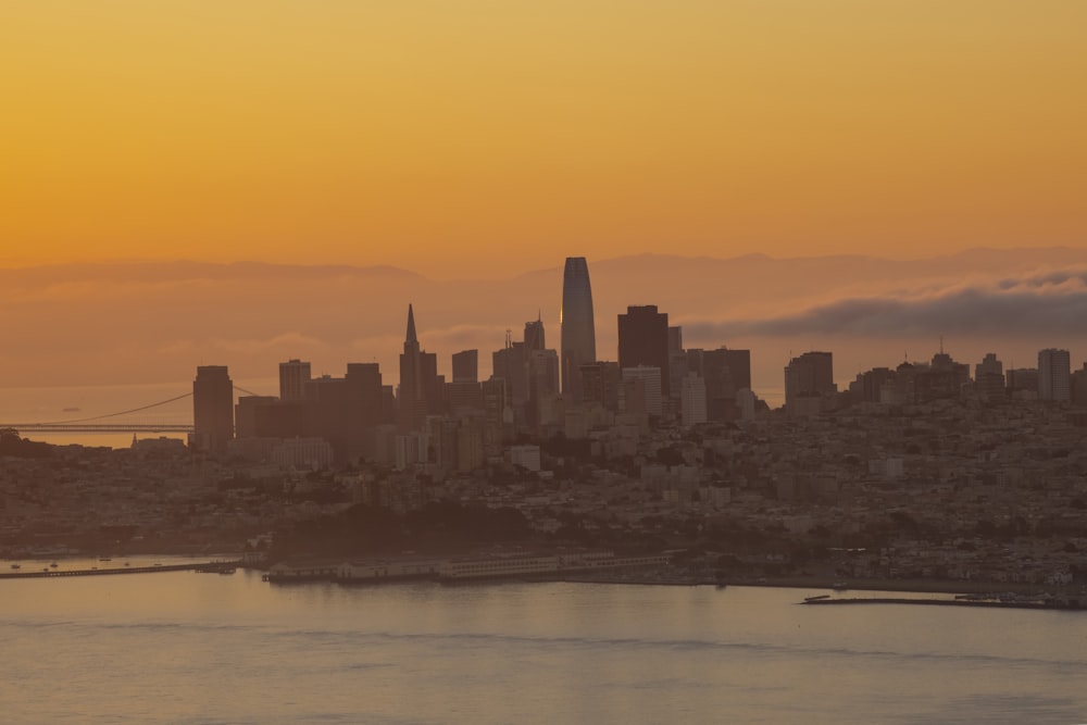 city skyline across body of water during daytime