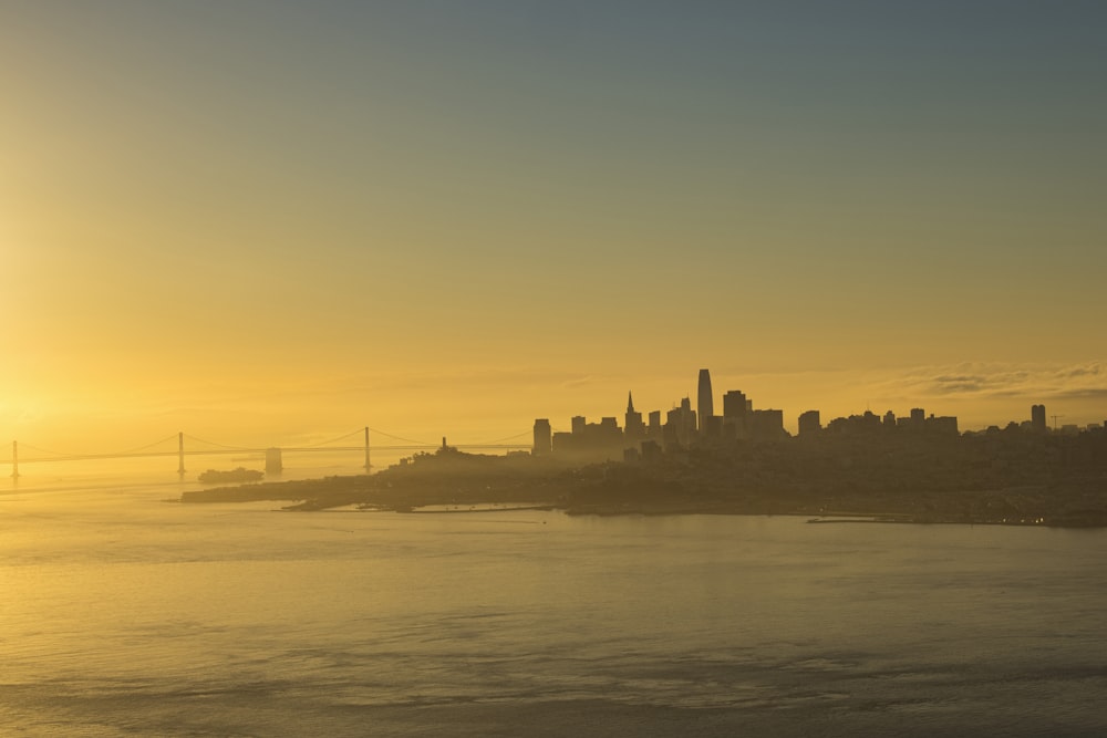 silhouette of city buildings during sunset