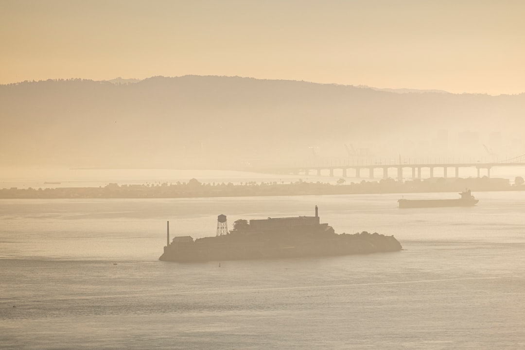 silhouette of ship on sea during sunset