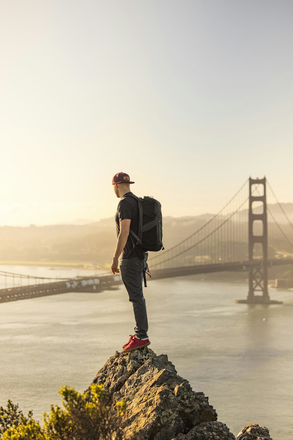 man in black t-shirt and black pants wearing red and black nike shoes standing on on on on with