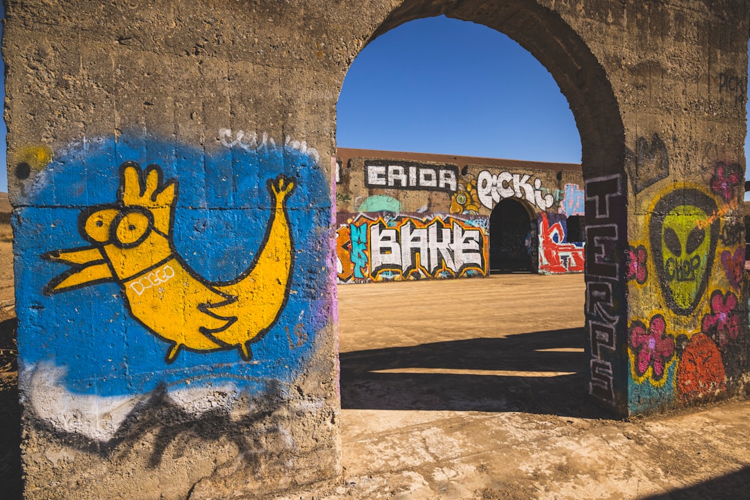 blue and yellow graffiti on wall