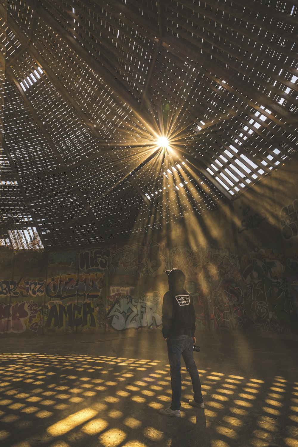 man in black jacket standing on tunnel