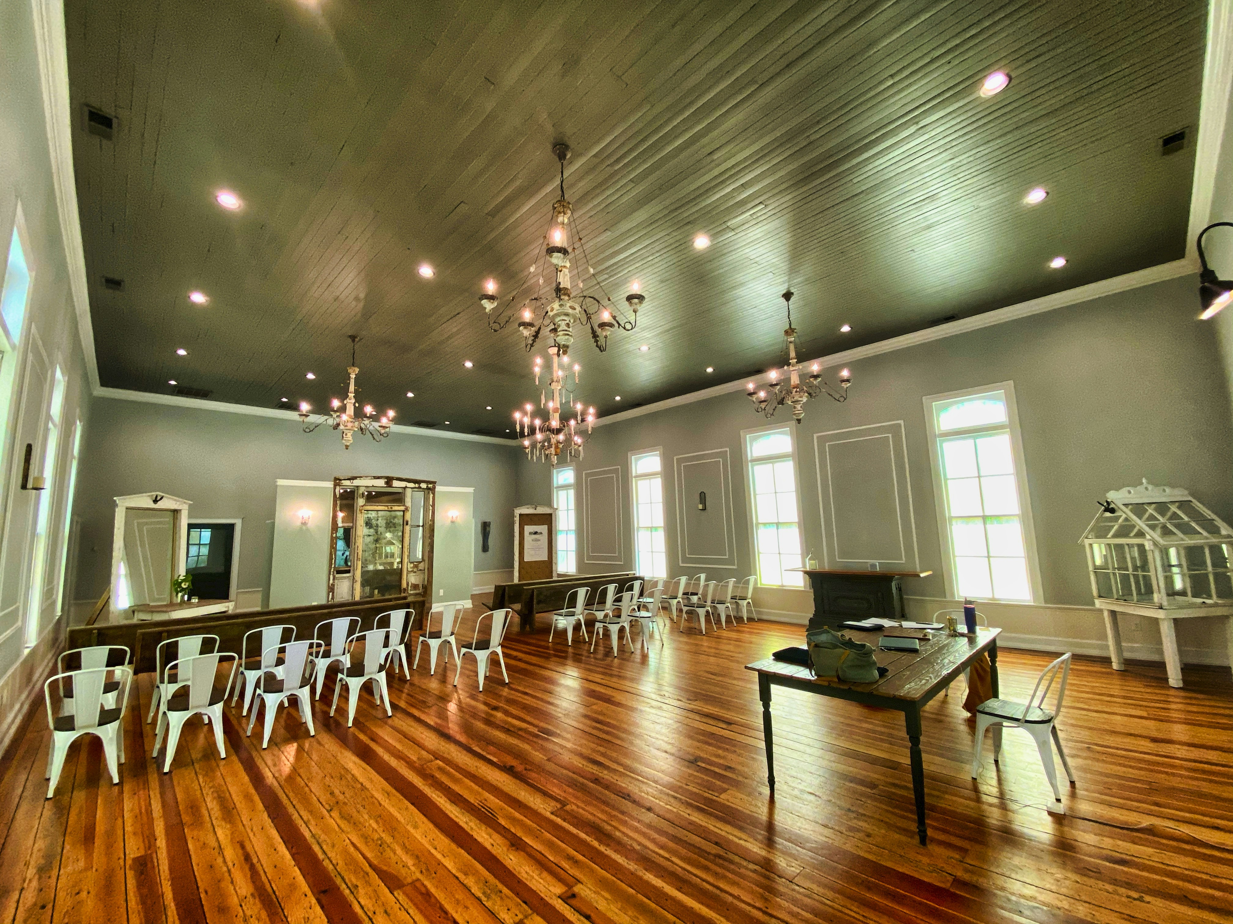 Empty event space with chairs stacked, ready to be arranged for a celebration