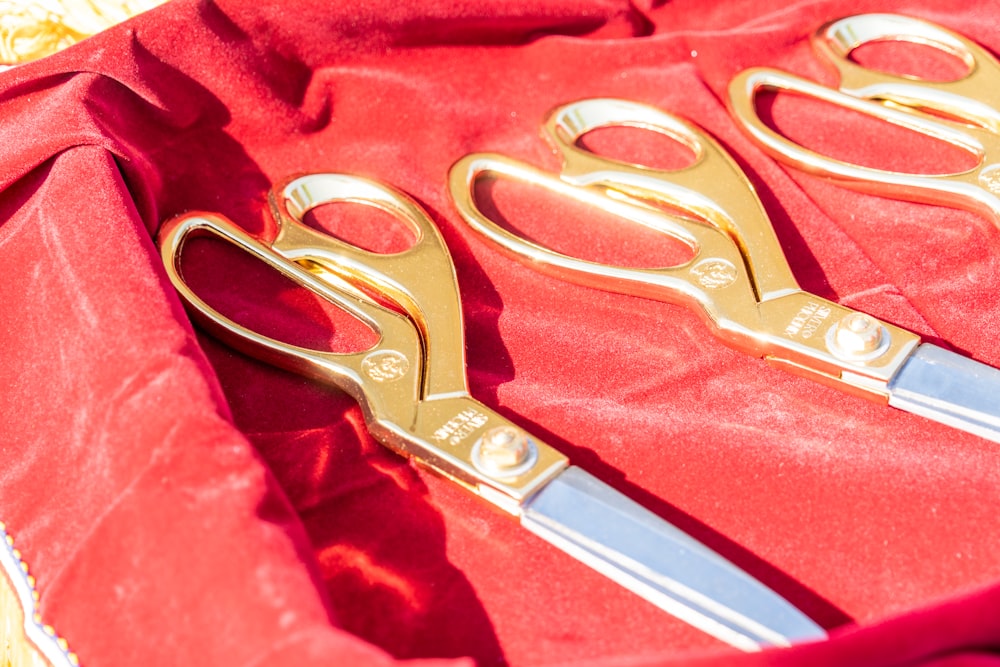 silver scissors on red textile