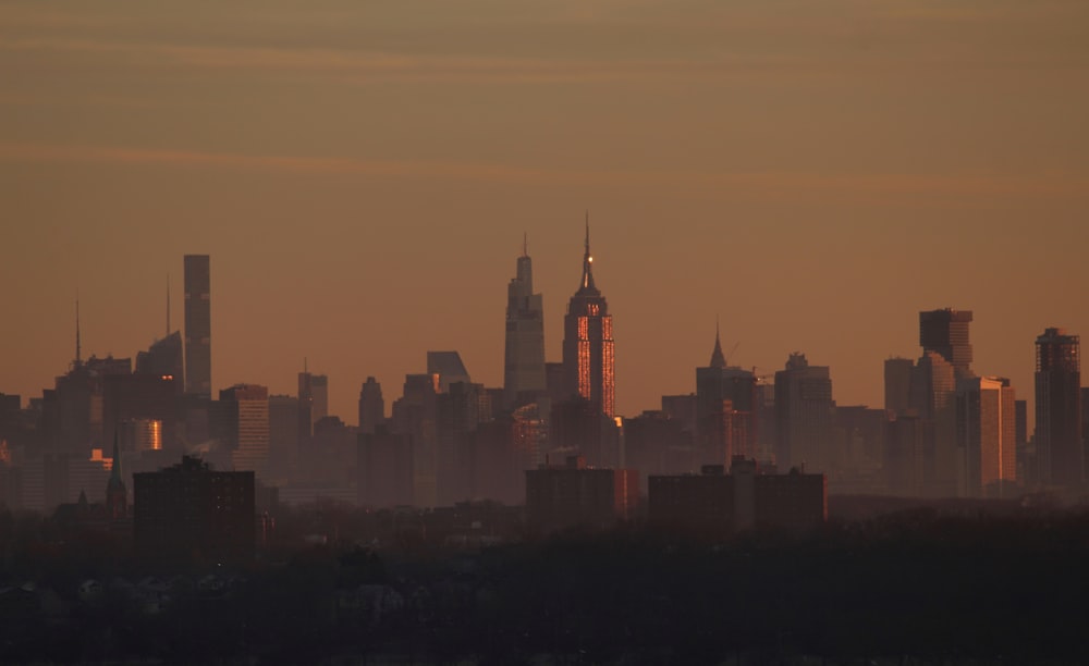 silhouette of city buildings during sunset