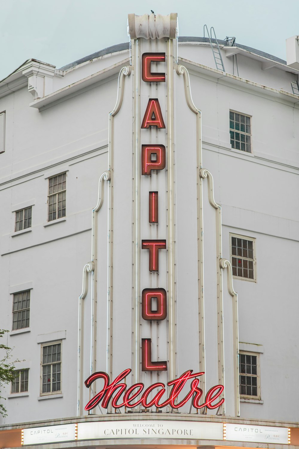 a large white building with a sign that says capitol theatre