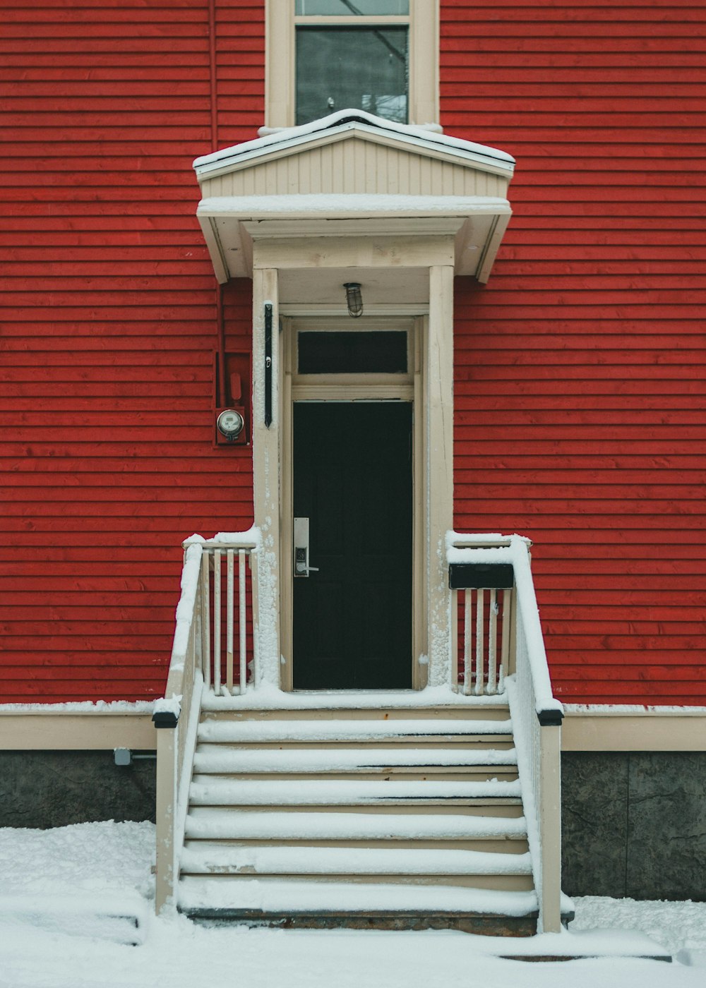 brown wooden door on red concrete building