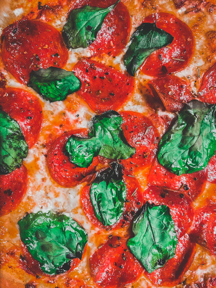 Close-up of a wood-fired pizza with tomato and basil