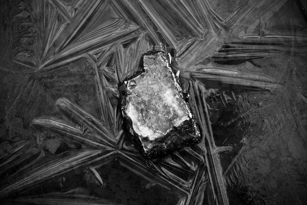 grayscale photo of broken glass