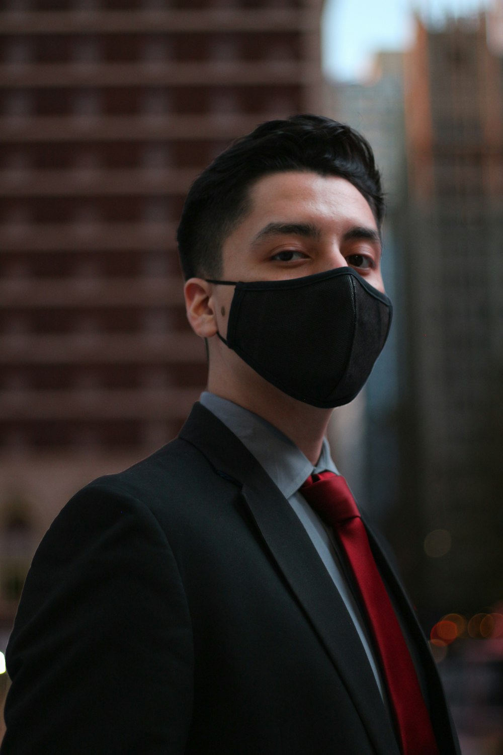 man in black suit wearing black mask