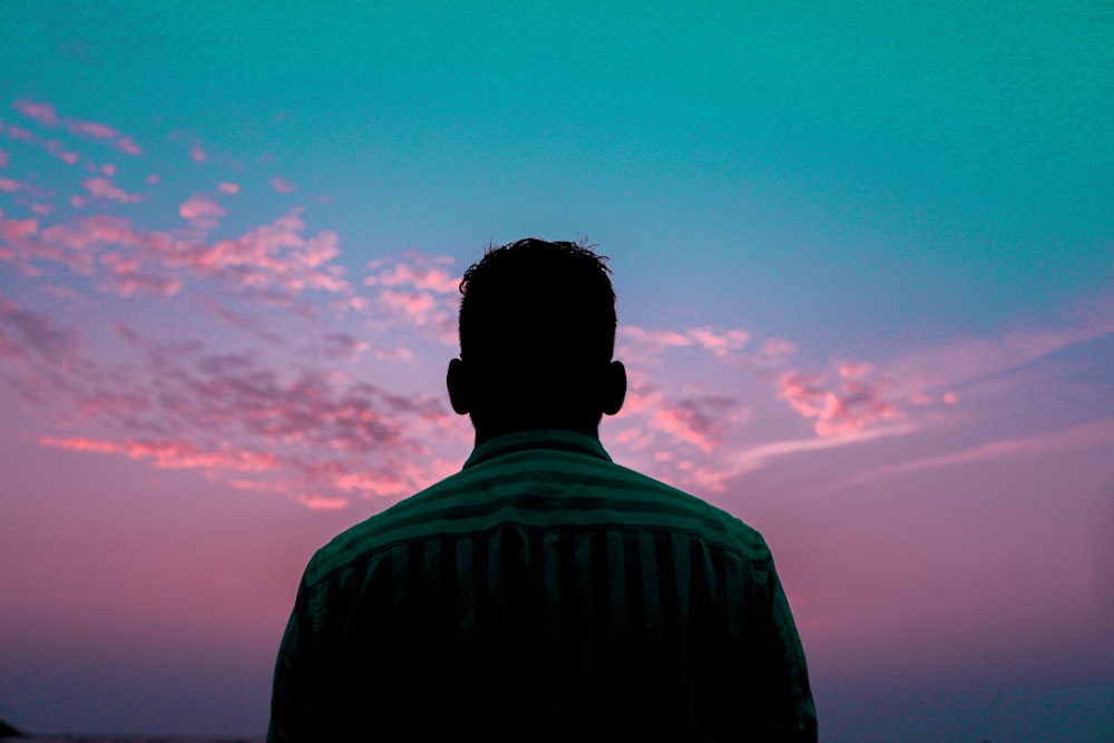 silhouette of man under blue sky during sunset