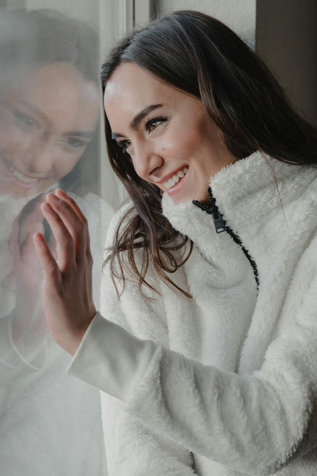 woman in white fur coat smiling