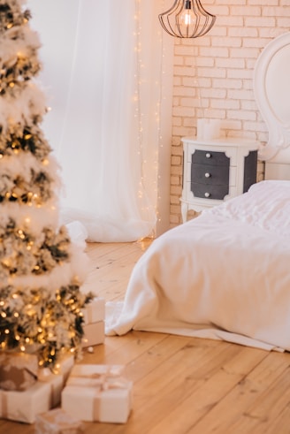 white bed near christmas tree