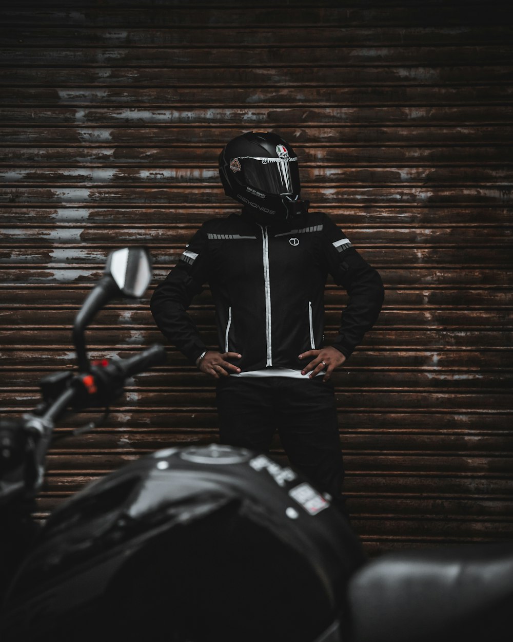 man in black leather jacket wearing black helmet