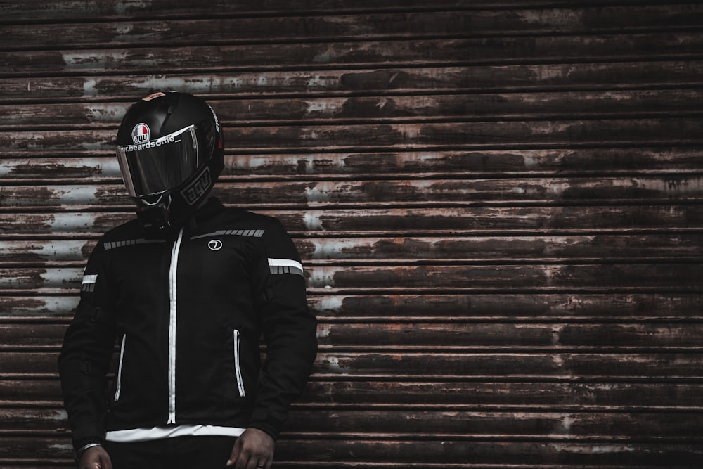 man in black and white zip up jacket wearing black helmet