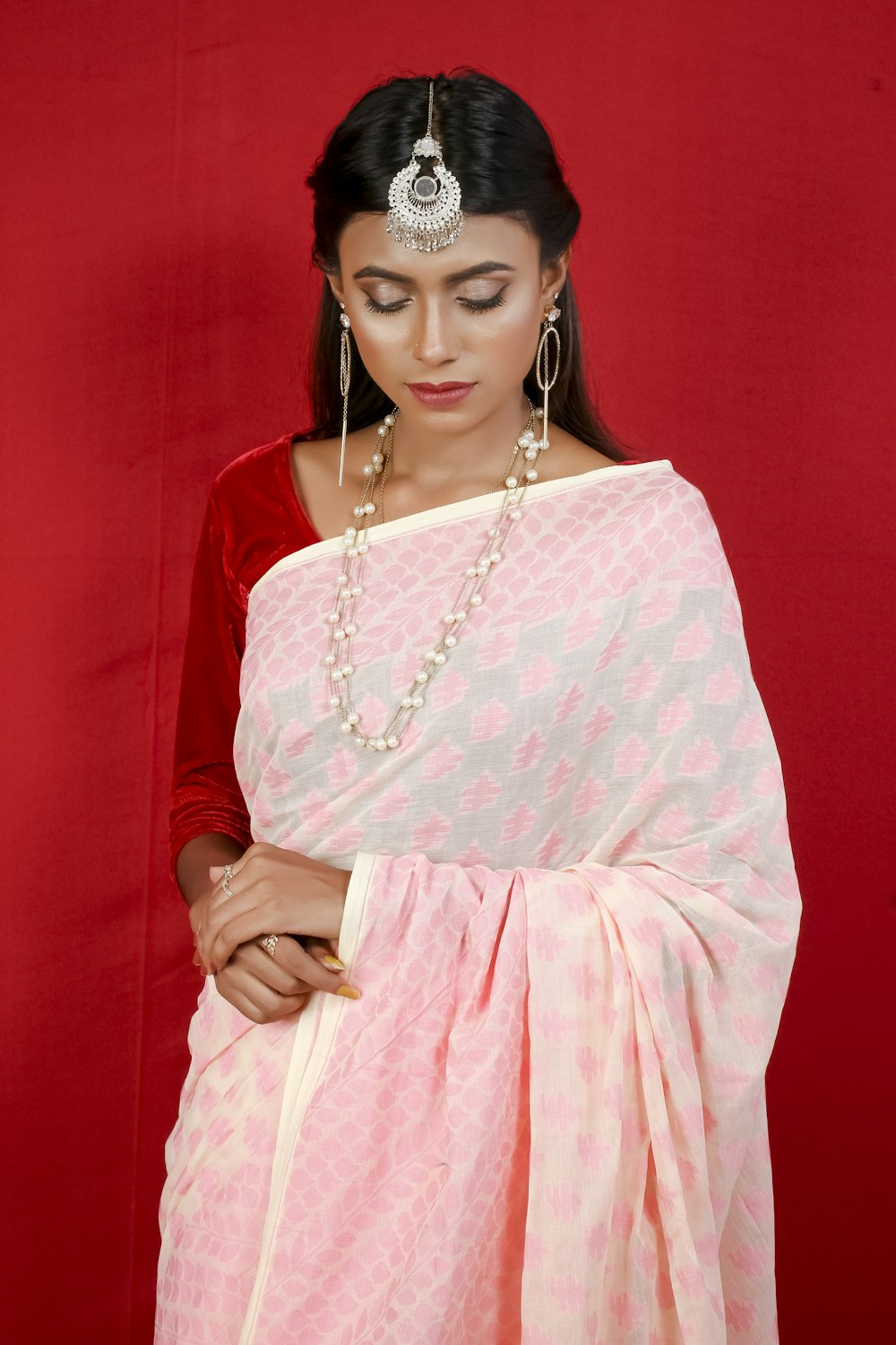 woman in pink and white dress wearing silver necklace