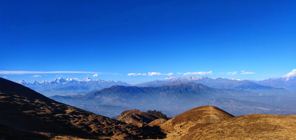 brown mountains under blue sky during daytime