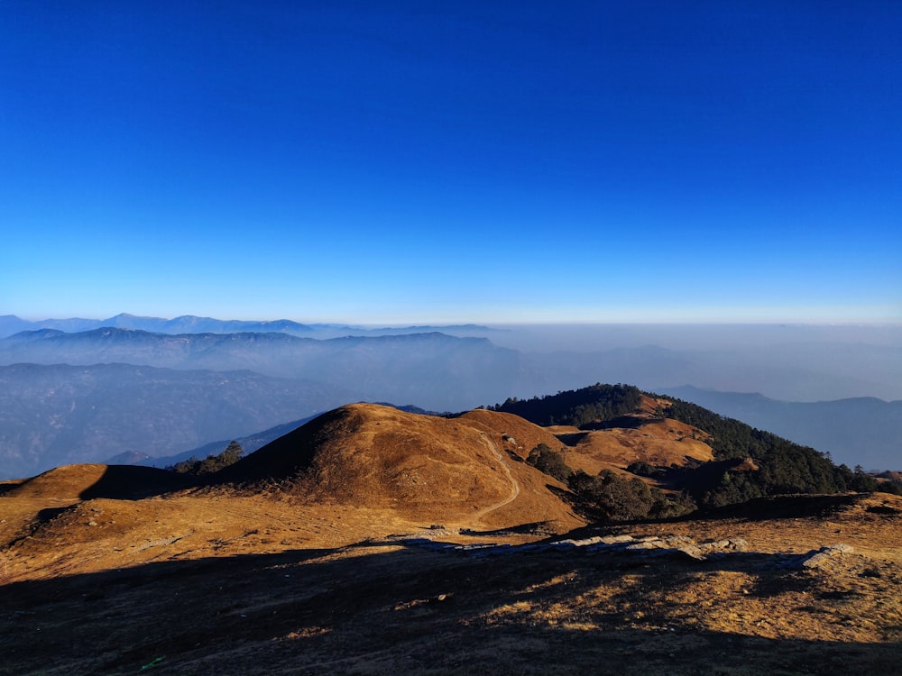 brown mountain under blue sky during daytime