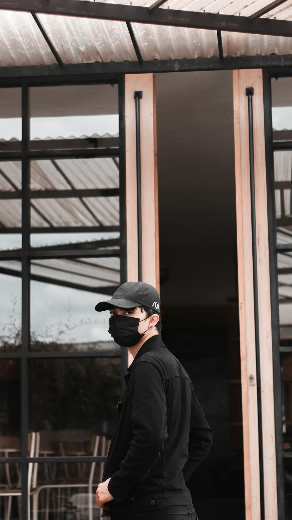 man in black jacket wearing black cap and black sunglasses