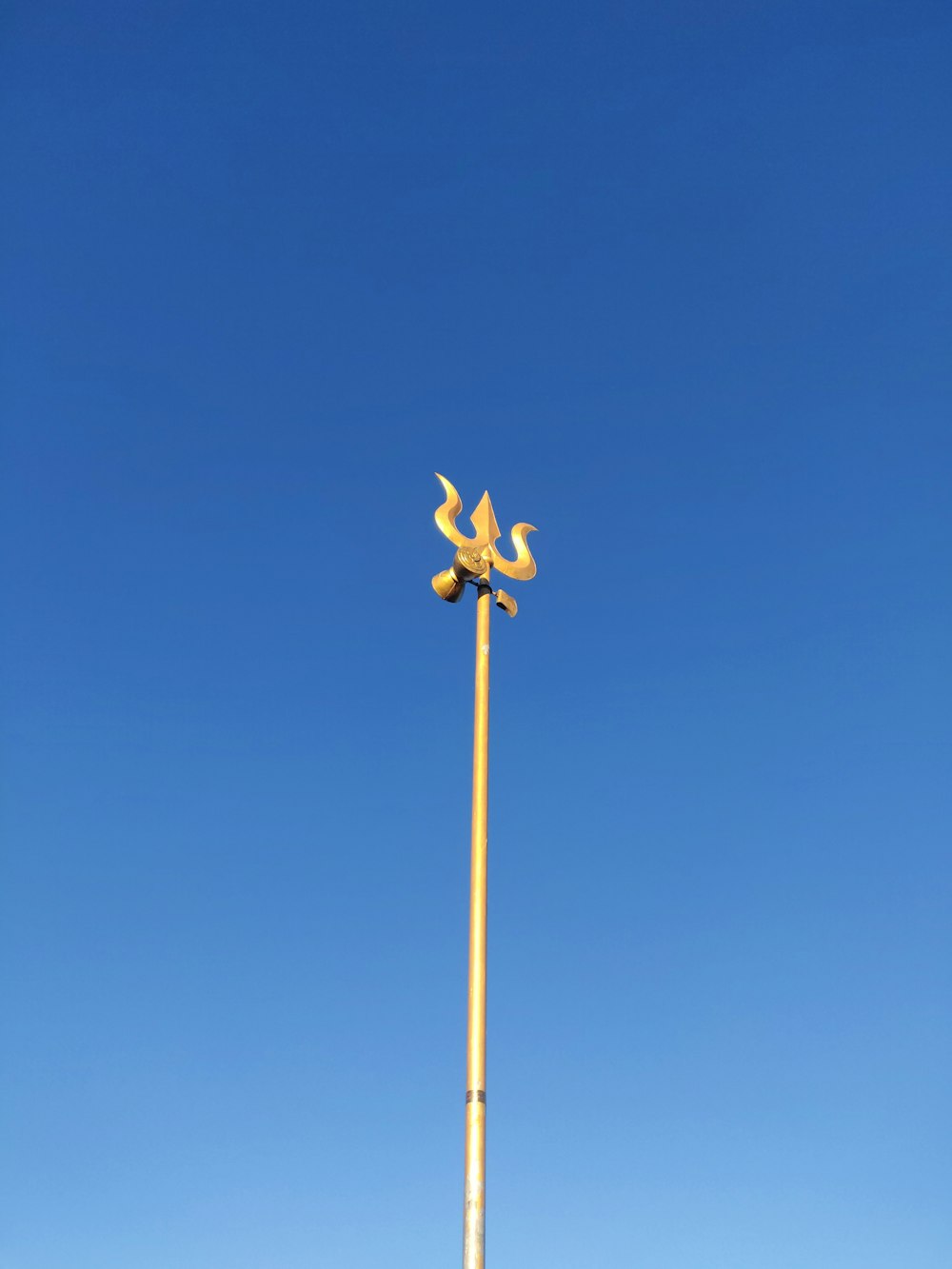 yellow and black wind mill under blue sky during daytime