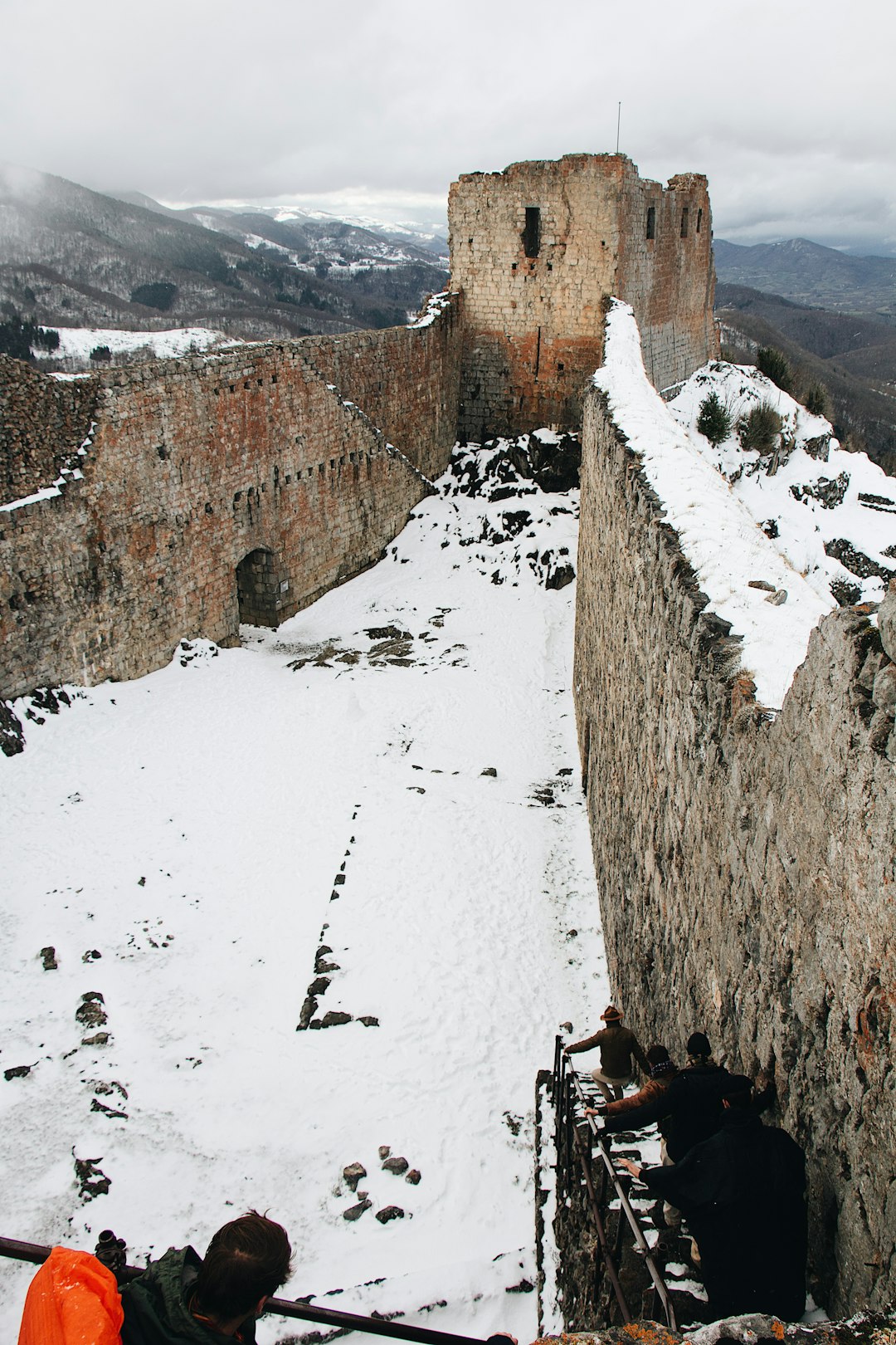 brown concrete building on snow covered ground during daytime