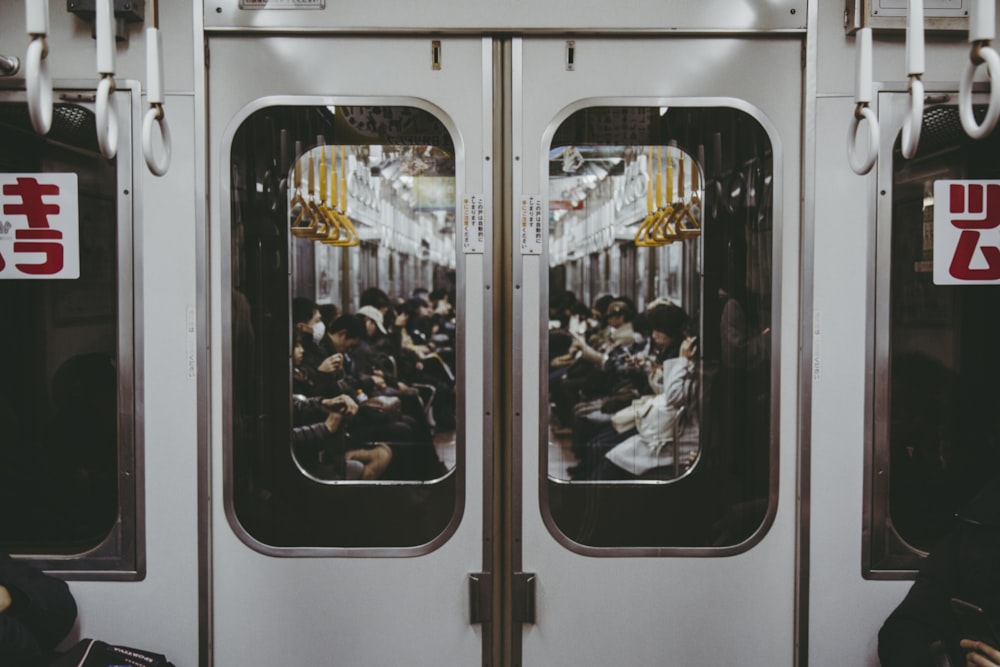 people inside white and black train