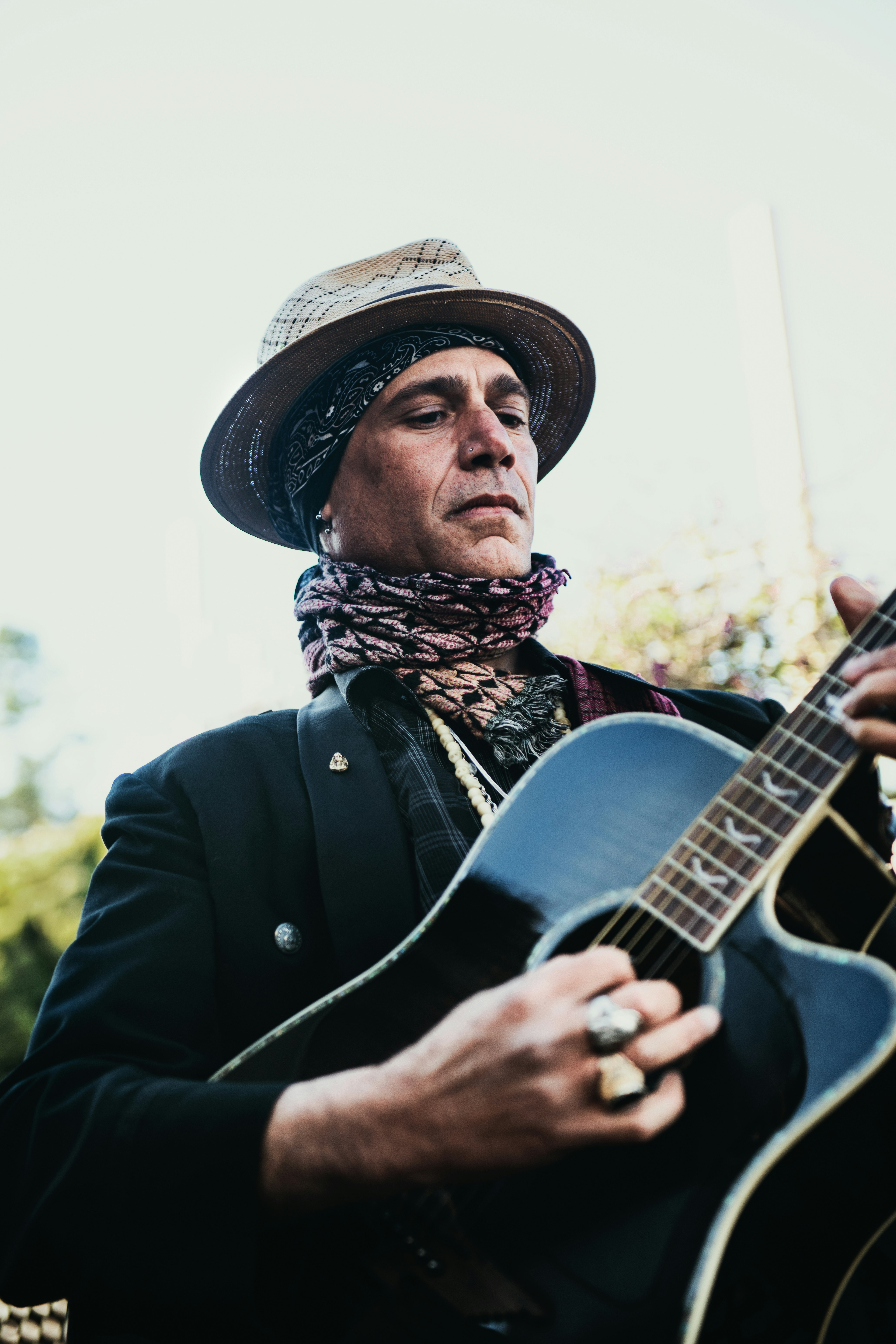 man in black coat playing guitar