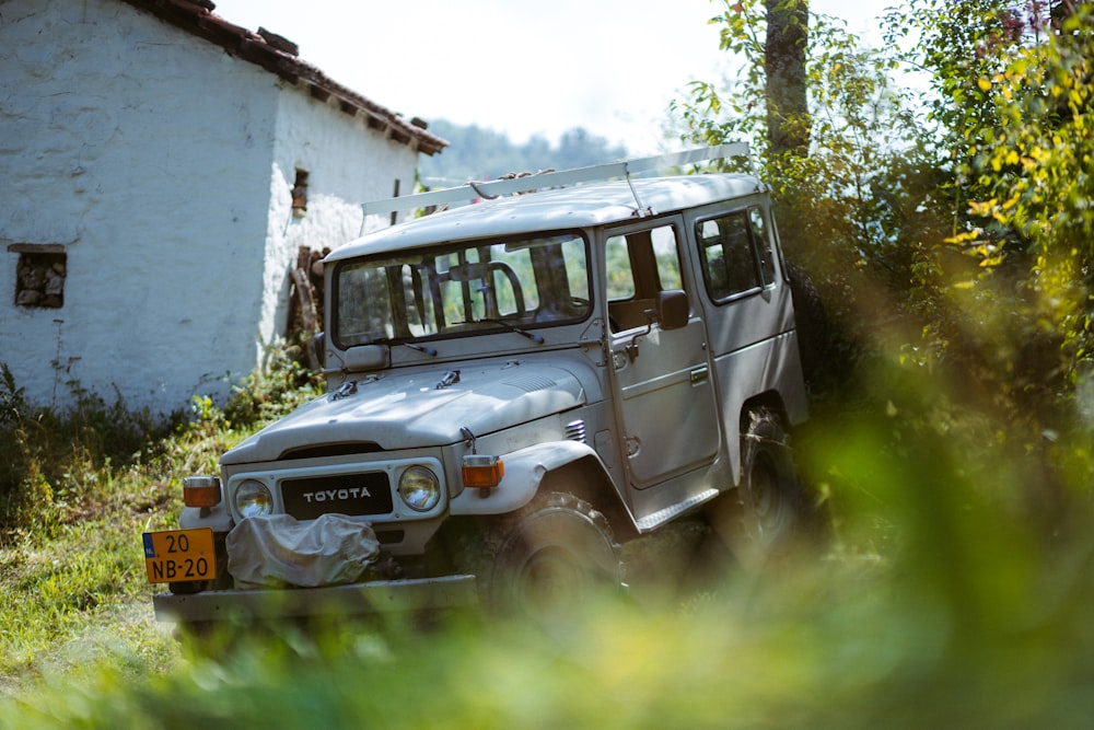 white and black suv on green grass field