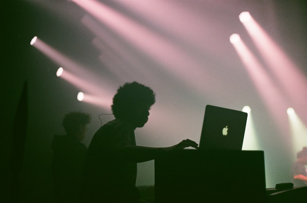 silhouette of man in front of laptop computer