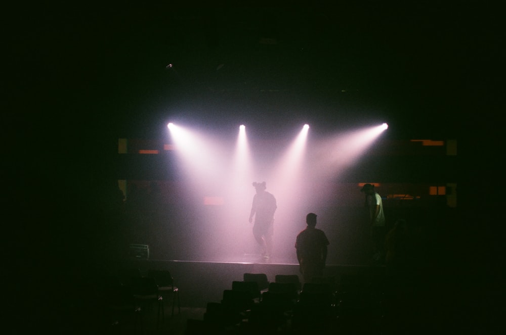 silhouette of people standing on stage