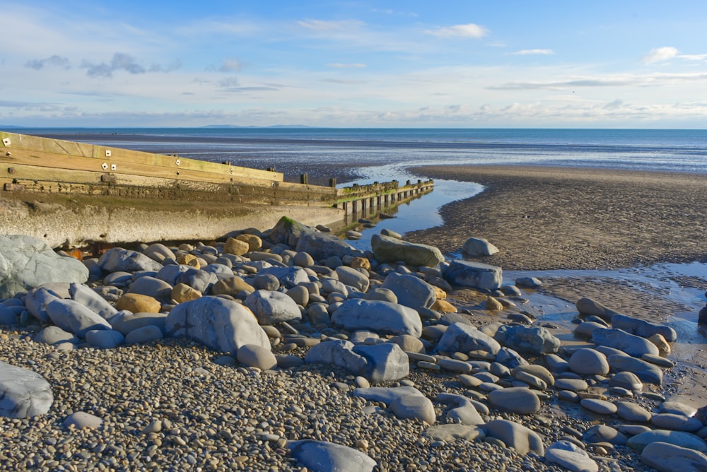 gray rocks on seashore during daytime