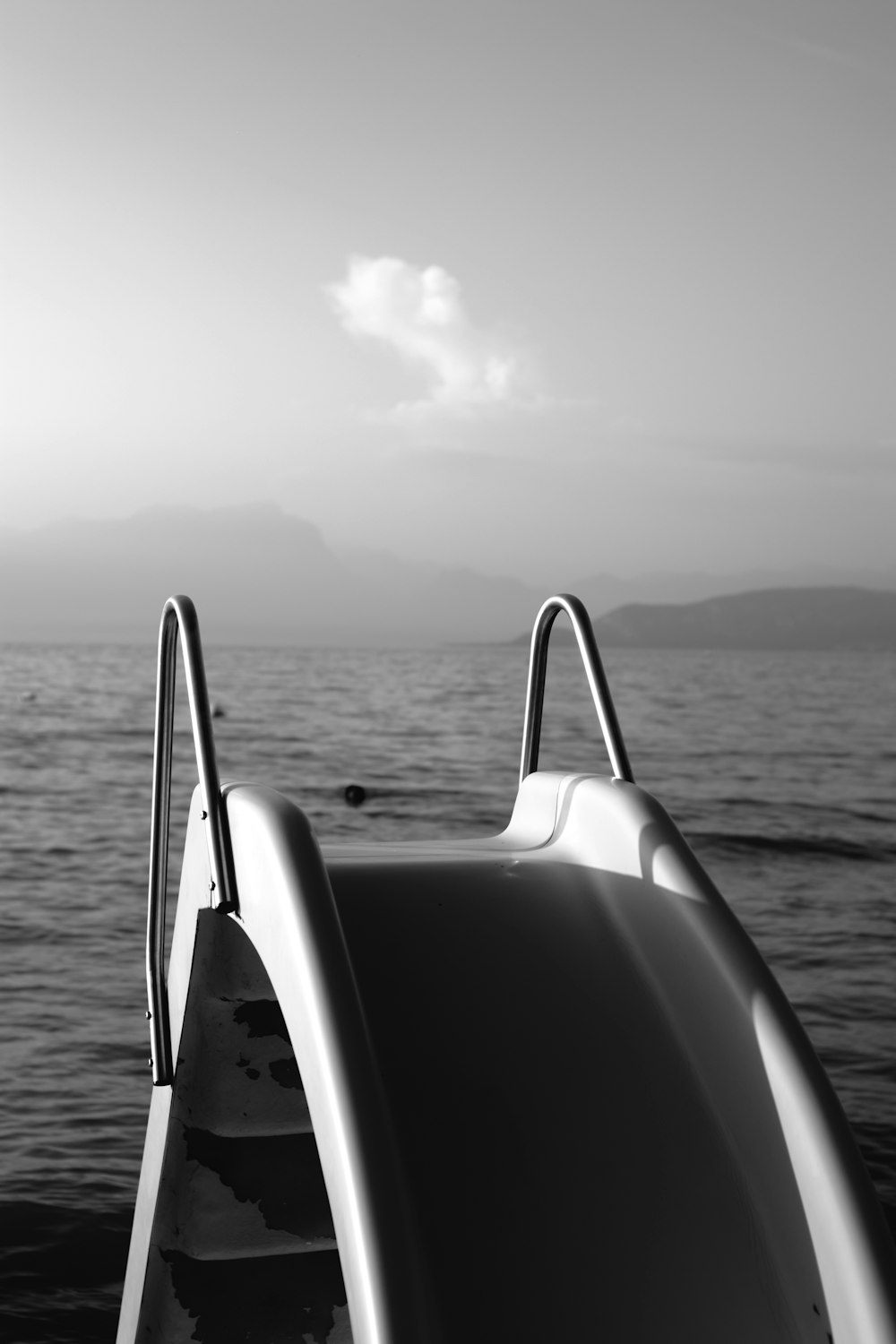grayscale photo of boat on sea