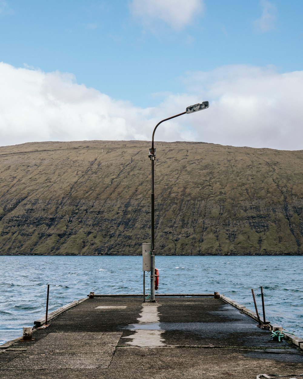 brown wooden dock on body of water during daytime