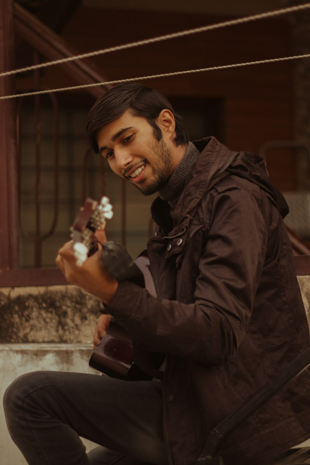 man in black jacket holding white and brown ceramic figurine