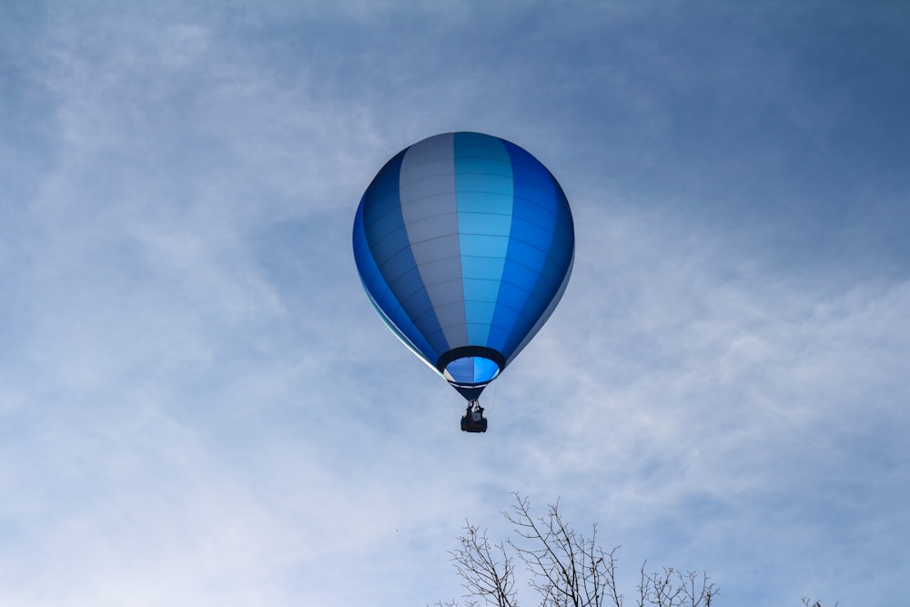 blue and white hot air balloon under blue sky during daytime